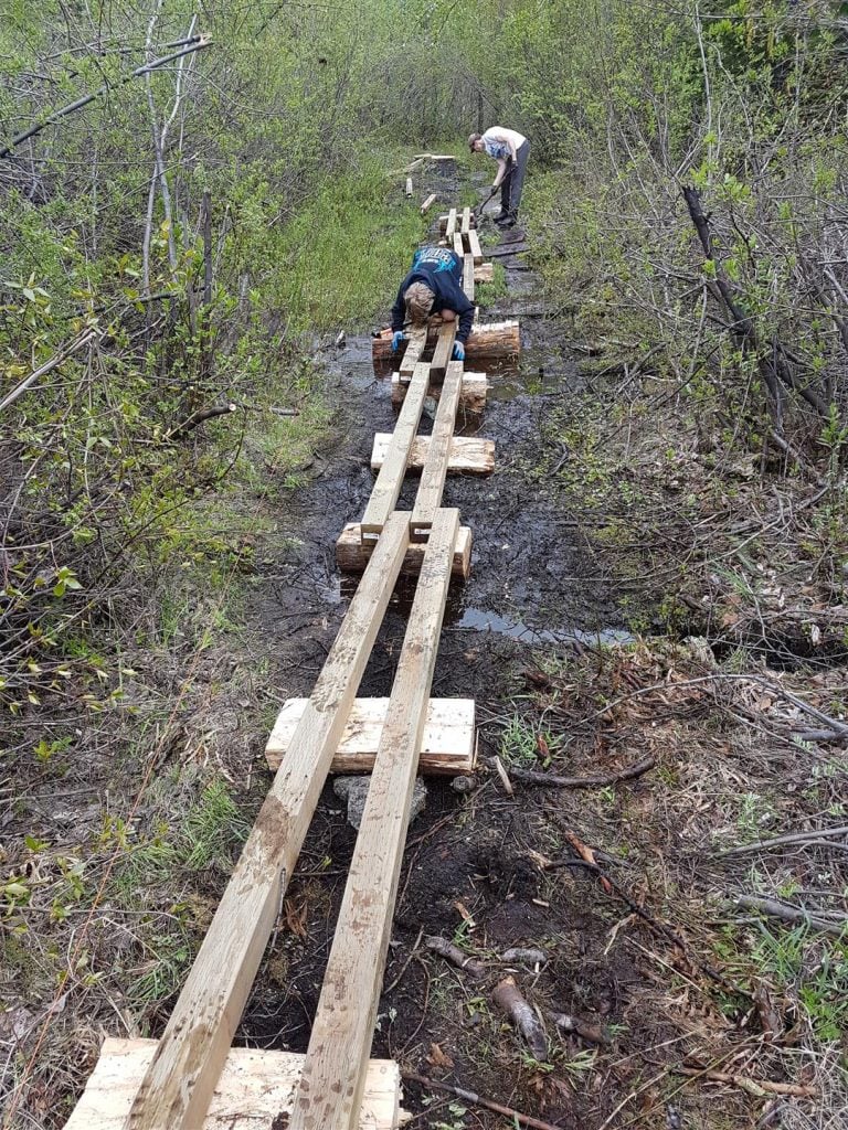 BCMC Crew lays the cedar rounds and stringers for the new Demon Creek Swamp Boardwalk (2017).