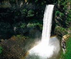 The mist from the waterfall creates a rainbow at the bottom of Brandywine Falls