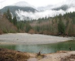 Looking across Gold Creek towards the snow-capped mountained in Golden Ears Provincial Park