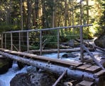 A bridge crossing 19 Mile Creek on the way up to Iceberg Lake