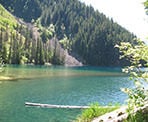 Looking across Lindeman Lake towards a rock slide on the other side