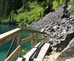 A wooden walkway along the trail that passes Lindeman Lake