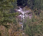 The view of Swan Falls in the distance from the road near Buntzen Lake