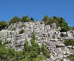Ascending the steep rocky sections near the top of the Lions
