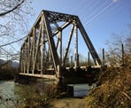 The trail passes under the train bridge